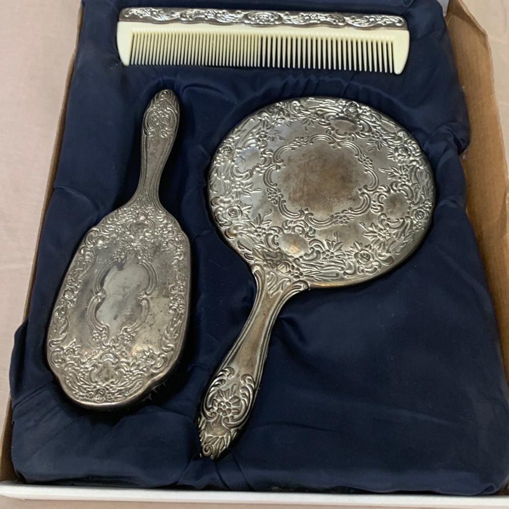 Vintage silverplate three piece grooming set. Comes w/ original lower box.